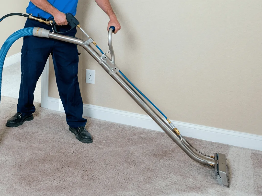 Professional operating a liquid removal machine on a carpeted floor in Indianapolis, IN